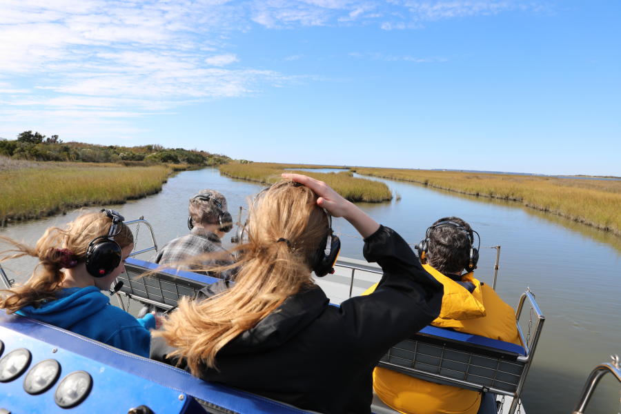 People on a airboat riding on the water
