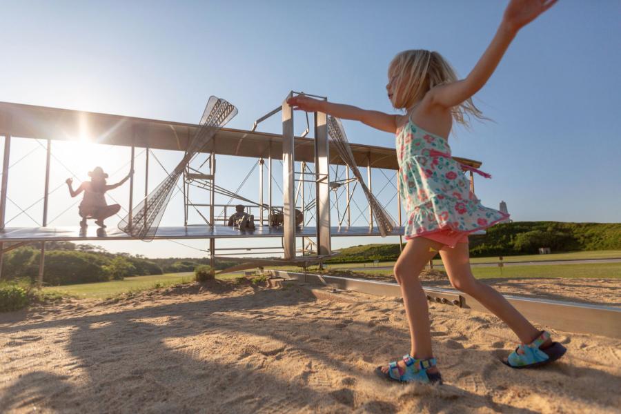 A kid playing at the wright brothers national memorial