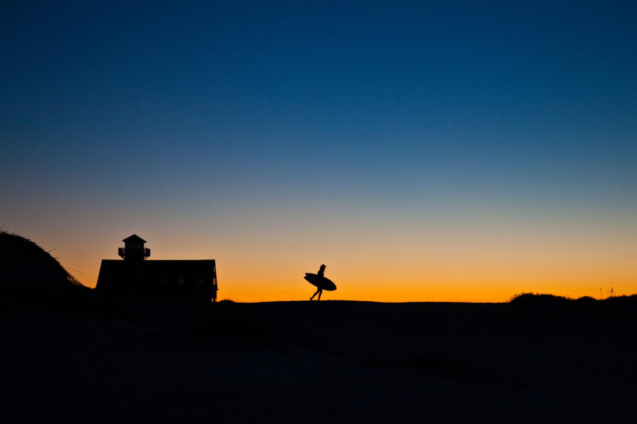 surfer at oregon inlet sunrise