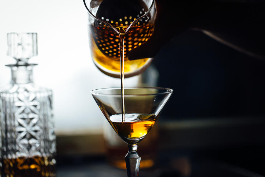 Puring a glass fo whiskey at truss & twine