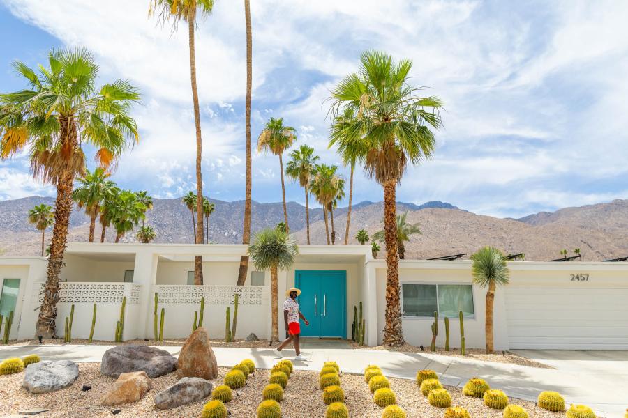 man walking in front of midcentury house in palm springs