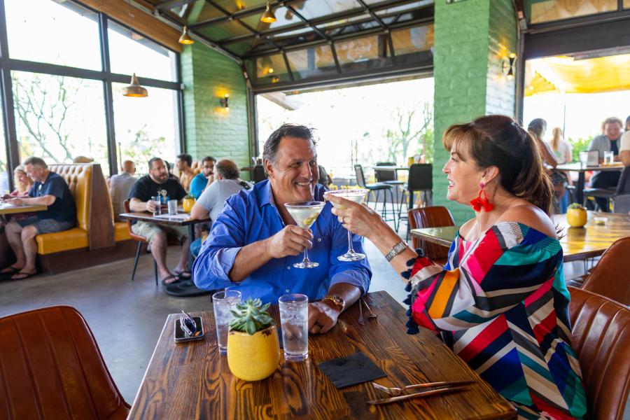 Couple toasting at 1501 Gastropub.