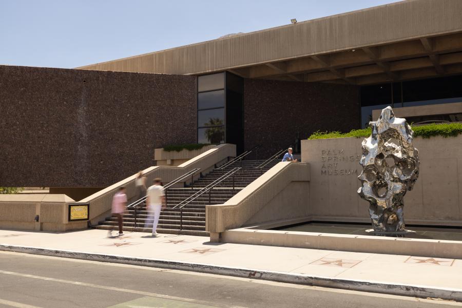Exterior of the Palm Springs Art Museum with stairs and sculpture.