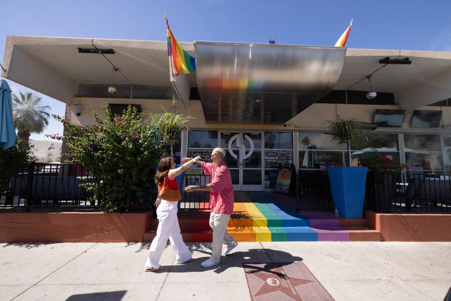 Two lesbian women getting ready to hug outside Hunters Palm Springs