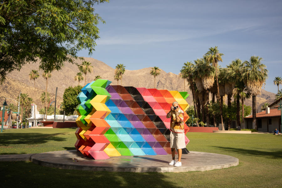 Women in front of the Palm Springs Pride Monument