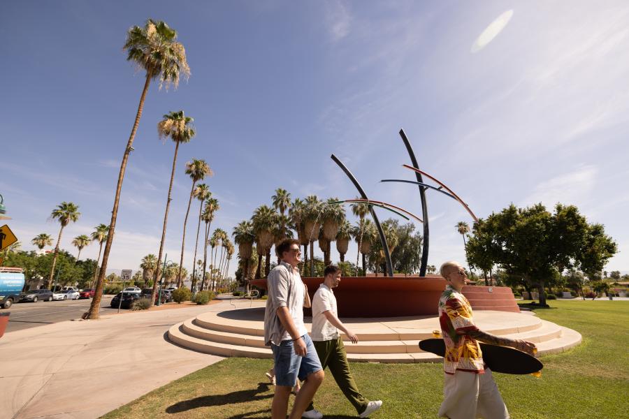 Three guys walking in front of the Fountain at Frances Stevens Park in Palm Springs.