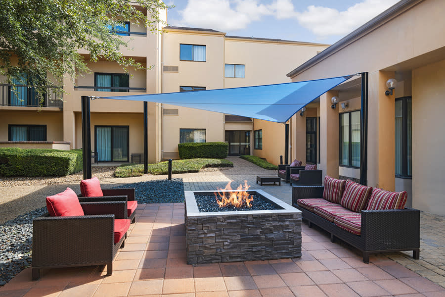 Outdoor hotel patio with covered awning and fire pit