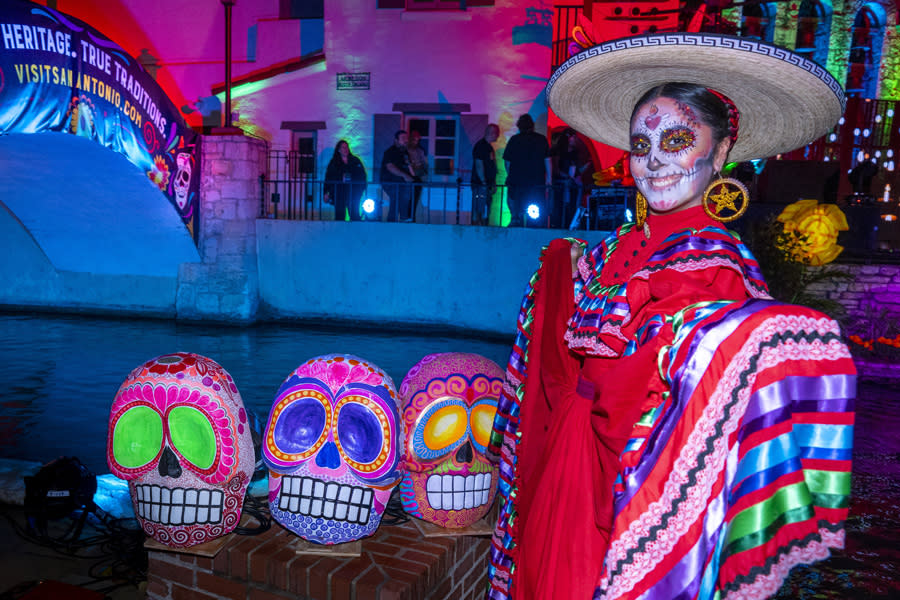 Woman dressed in pancho with sugar skull face painting