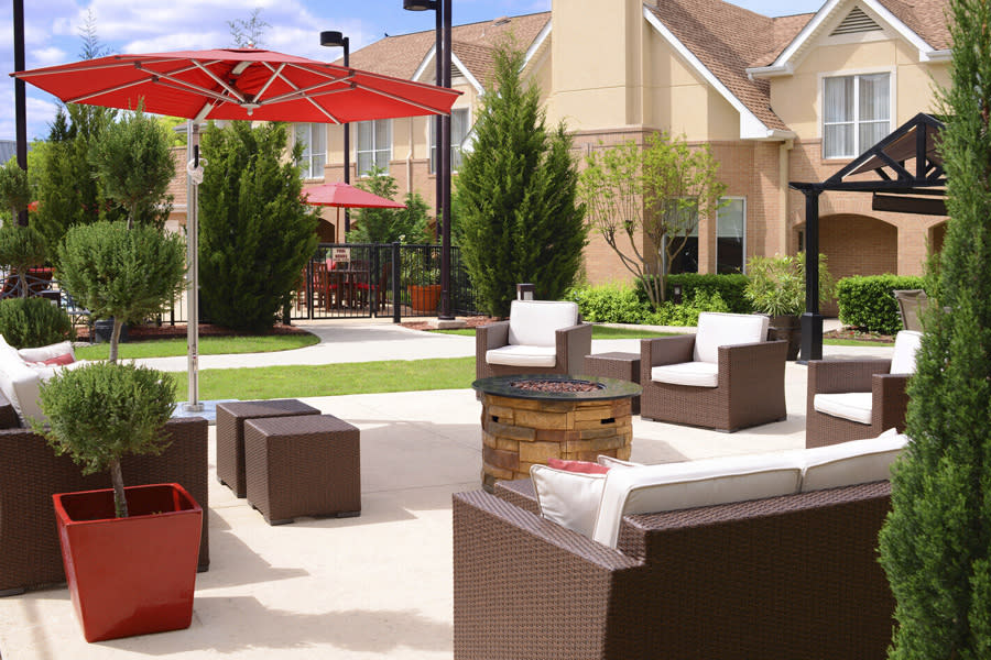 Outdoor hotel patio with red umbrella