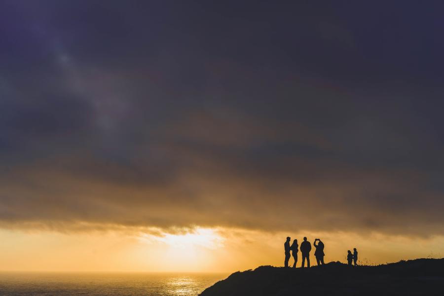 Group of friends taking photos of sky at Devil's Slide Trail