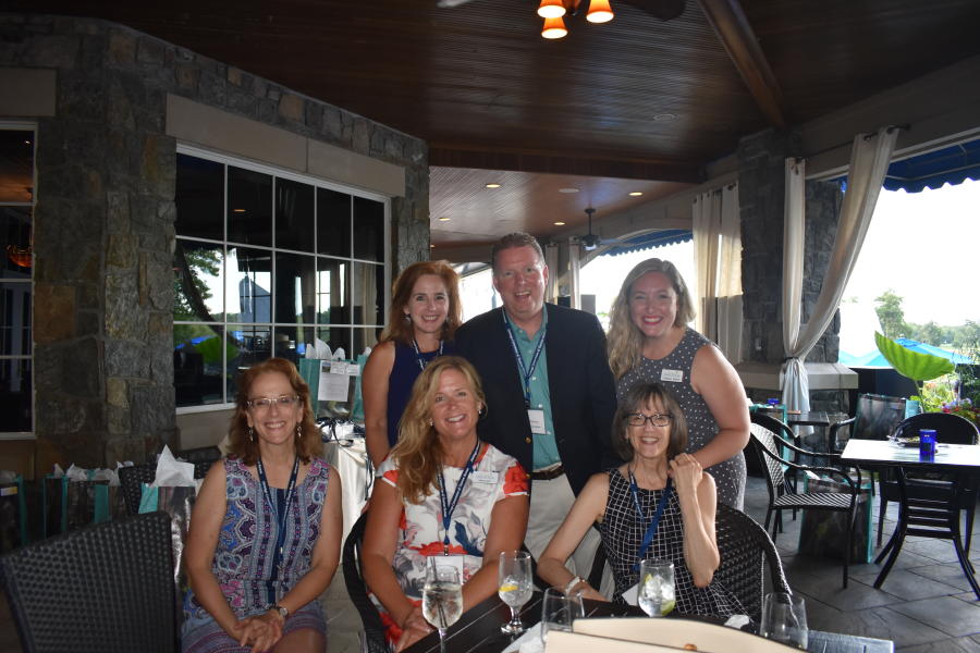 Small group smiling for camera at Saratoga National networking event
