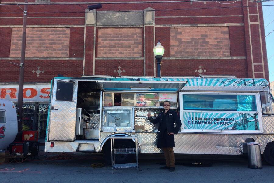 The proprietor stands in front of Lone Wolf food truck in Tulsa, OK.