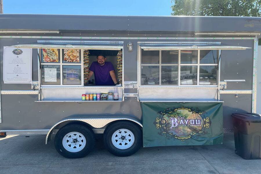 The chef stands in the window of Bayou food truck in Tulsa, OK.