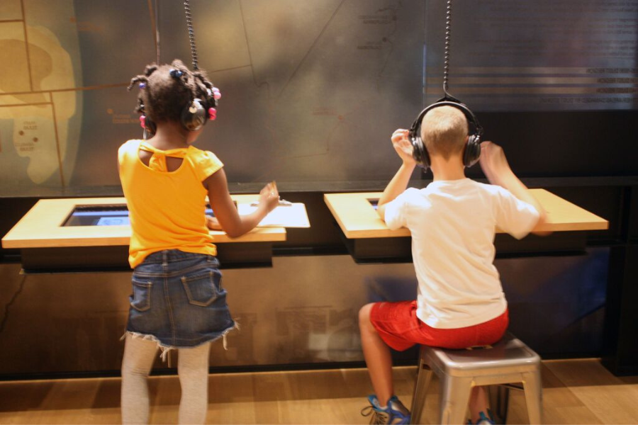 Kids Listening to an exhibit at Woody Guthrie Center in Tulsa, OK
