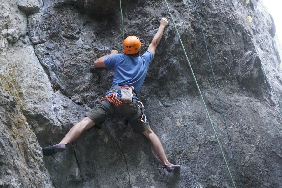 Young man rock climbing