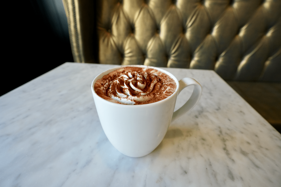 Mug of chocolate with whipped cream in rosette shape