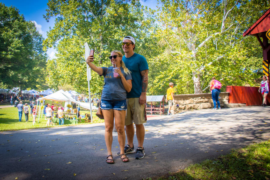 A couple taking a selfie at the Covered Bridge Festival