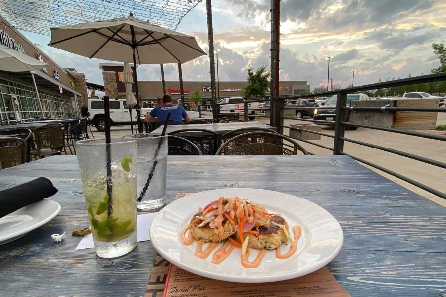 Photo of plate of food on patio at Social House