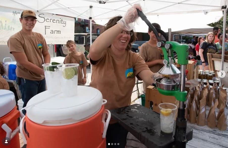 A young man squeezes lemons to make lemonade at Orie's garlic fest in Wichita, KS.