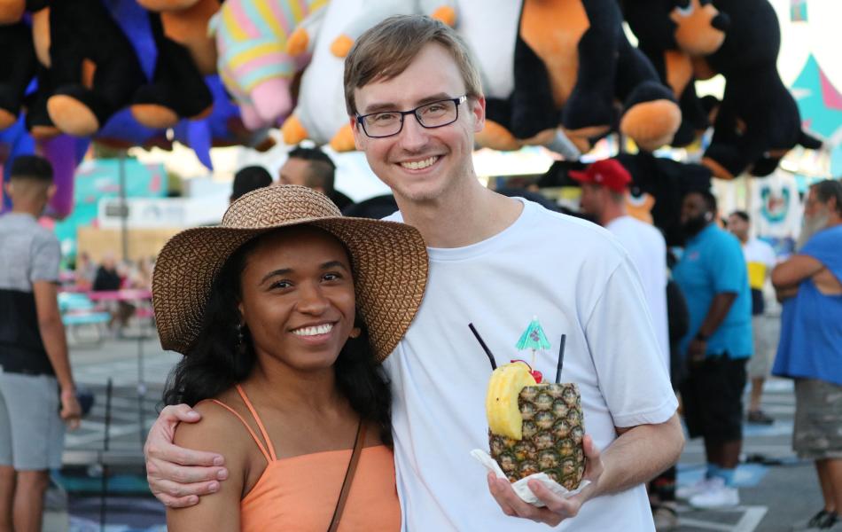A couple sharing a pineapple drink at the Oklahoma State Fair