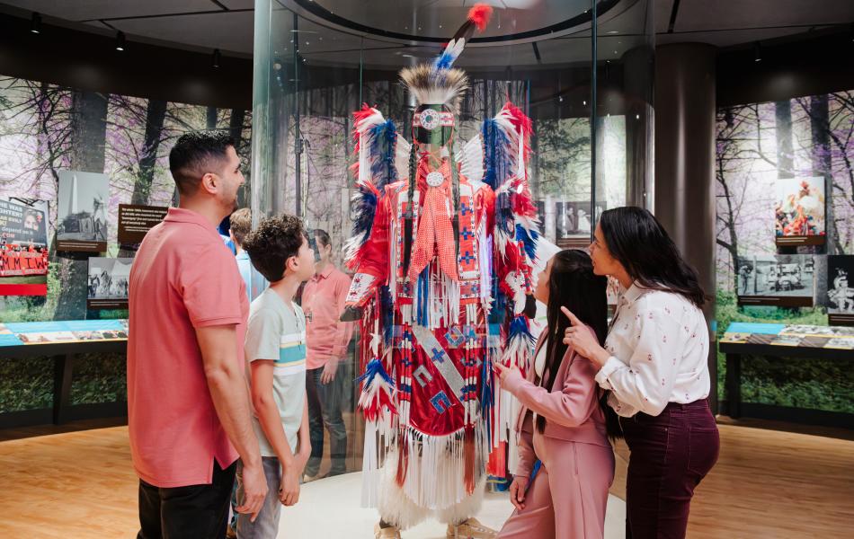 Family looking at Native American regalia at First Americans Museum