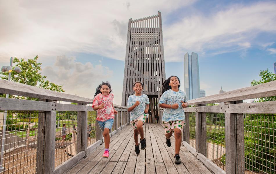 3 kids running at the playground at Scissortail Park in Oklahoma City