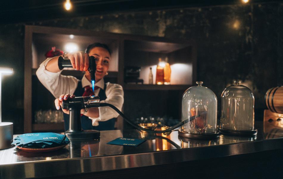 A bar tender preparing a drink