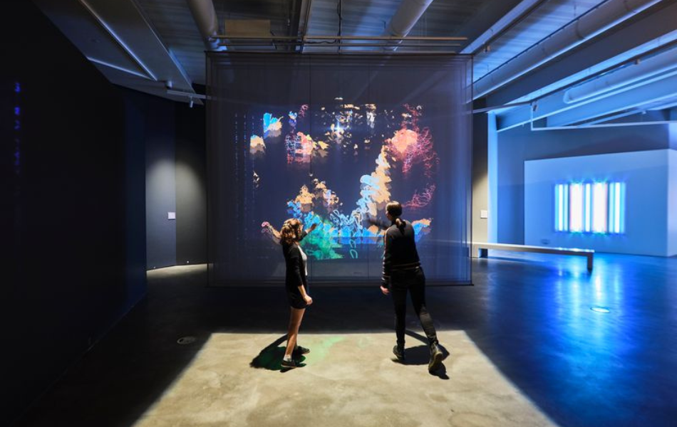 Two people in front of an interactive screen at Oklahoma Contemporary