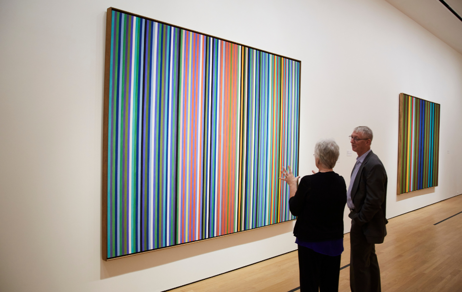 A couple looking at a painting at the OKCMOA