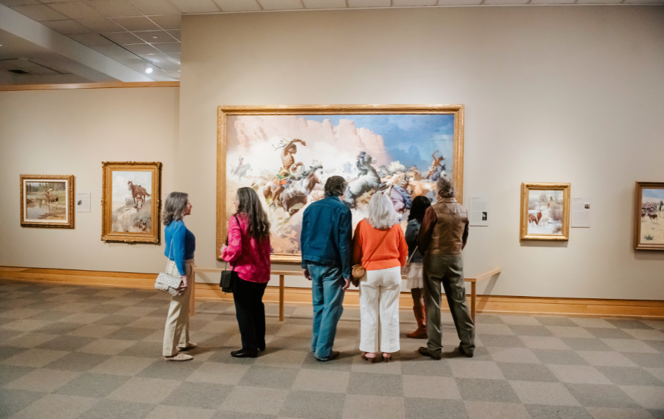 Group looking at the painting at the National Cowboy & Western Heritage Museum