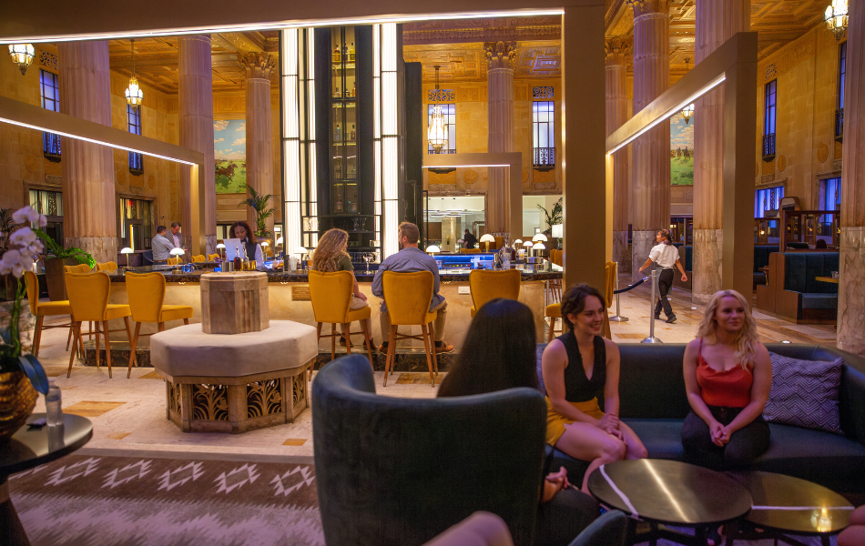 People sitting at the bar and on couches at the National