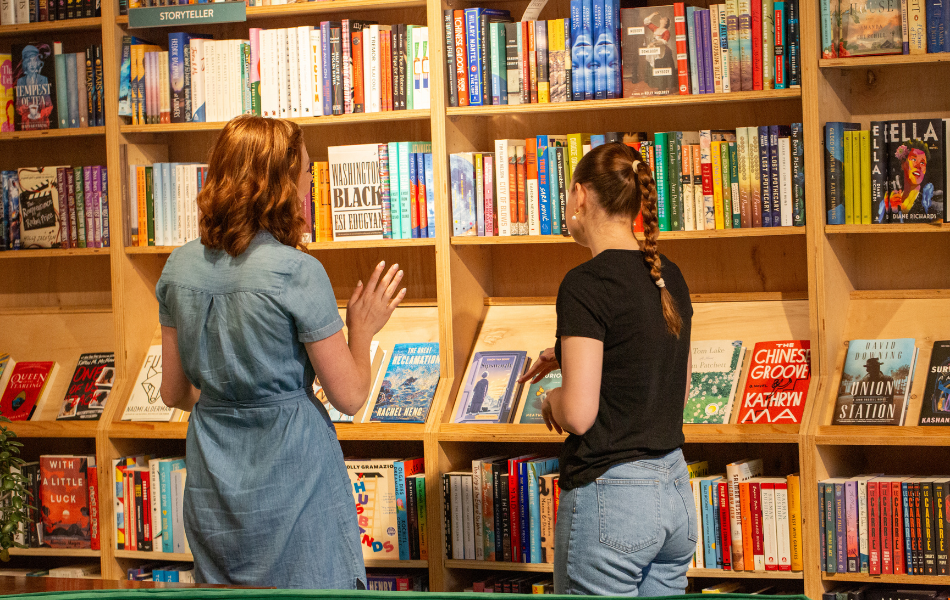 Two women looking at bookshelf at Commonplace Books