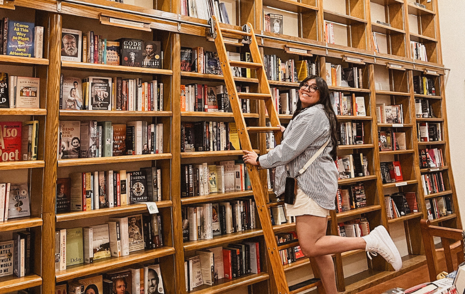 Woman on library ladder at Full Circle Bookstore