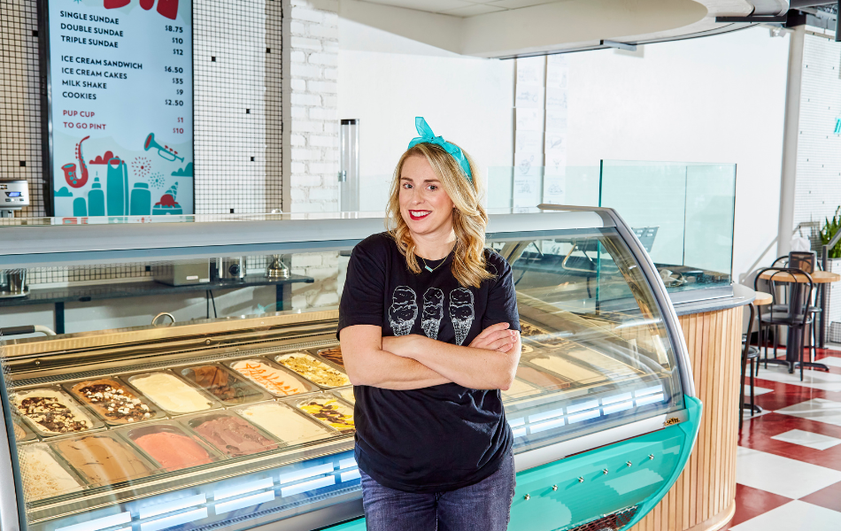 Owner of Boom Town standing in front of ice cream window