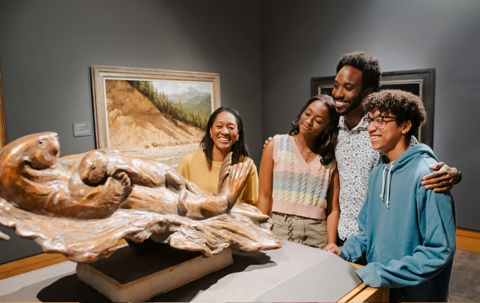 A family of four looking at an otter statue at the National Cowboy & Western Heritage Museum