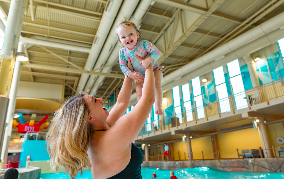 A mother holding her child up in the air