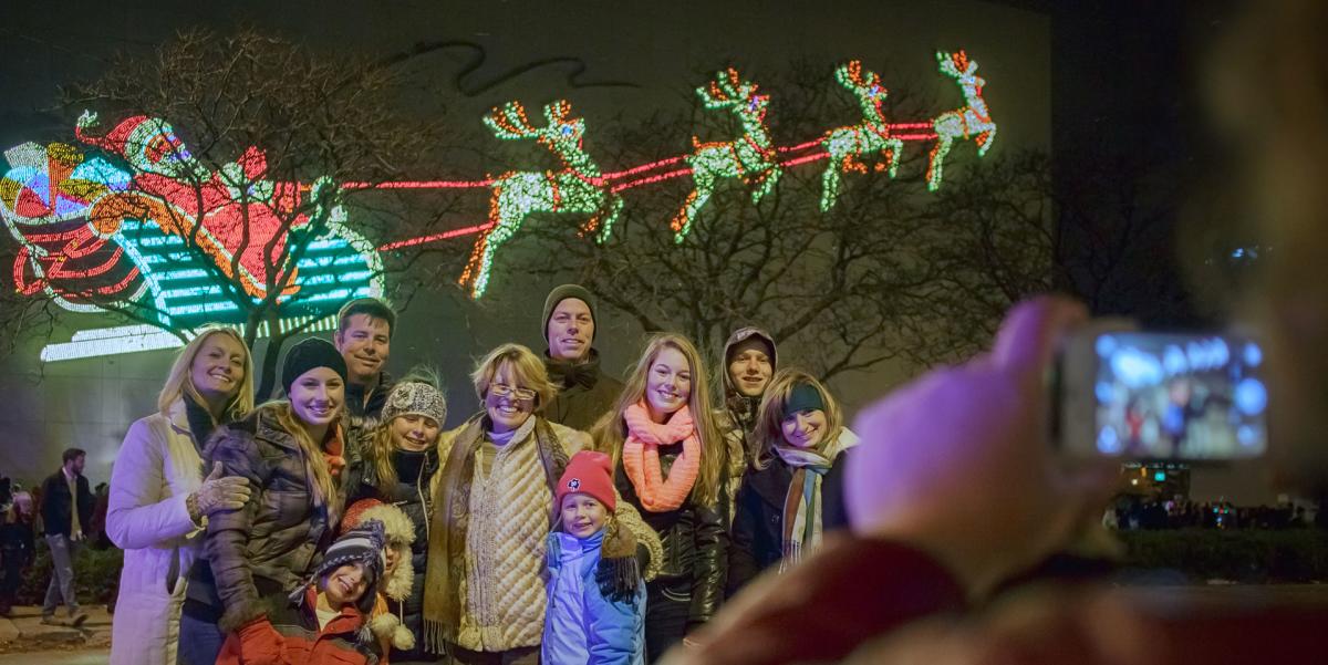 Family posing for a picture at Night of Lights in Downtown Fort Wayne