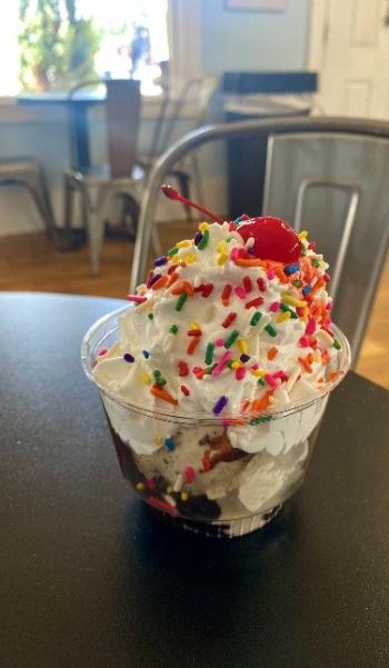 Image of a classic hot fudge sundae with rainbow sprinkles