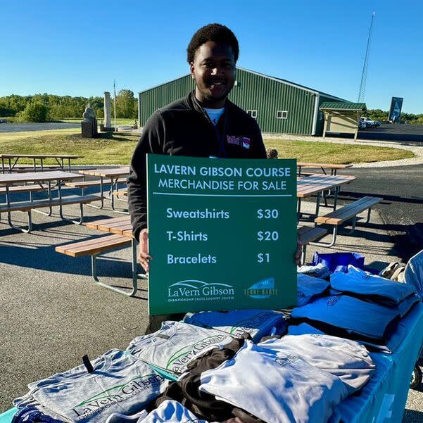 Justin helps sell t-shirts at one of many fall cross country events at the LaVern Gibson Cross Country Course.