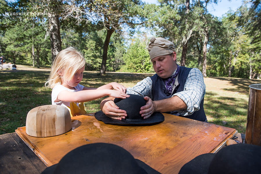 a man constructing a felt hat with a children at a heritage event at brunswick town