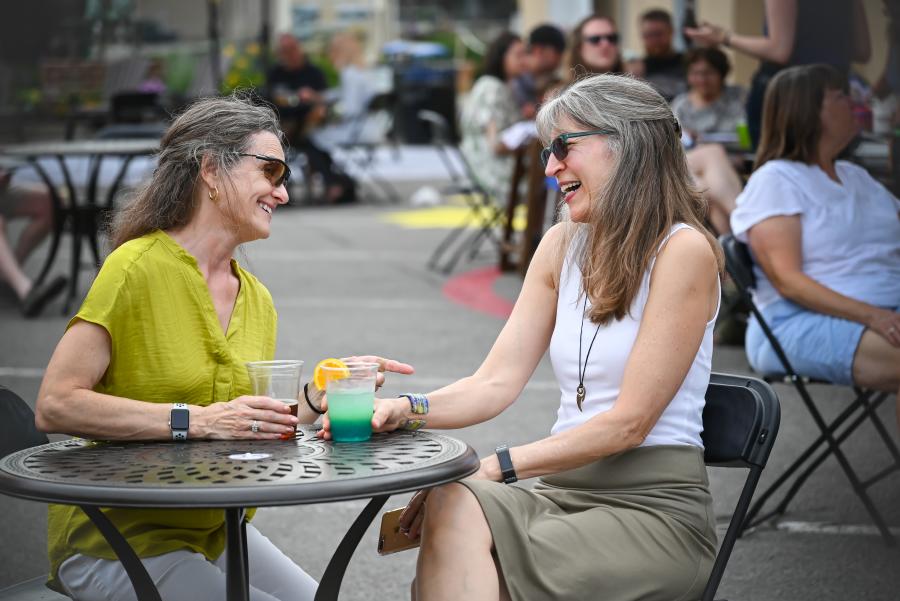 Women enjoying a drink at Central on Main, on Main Street, Canandaigua, during the spring or summer.