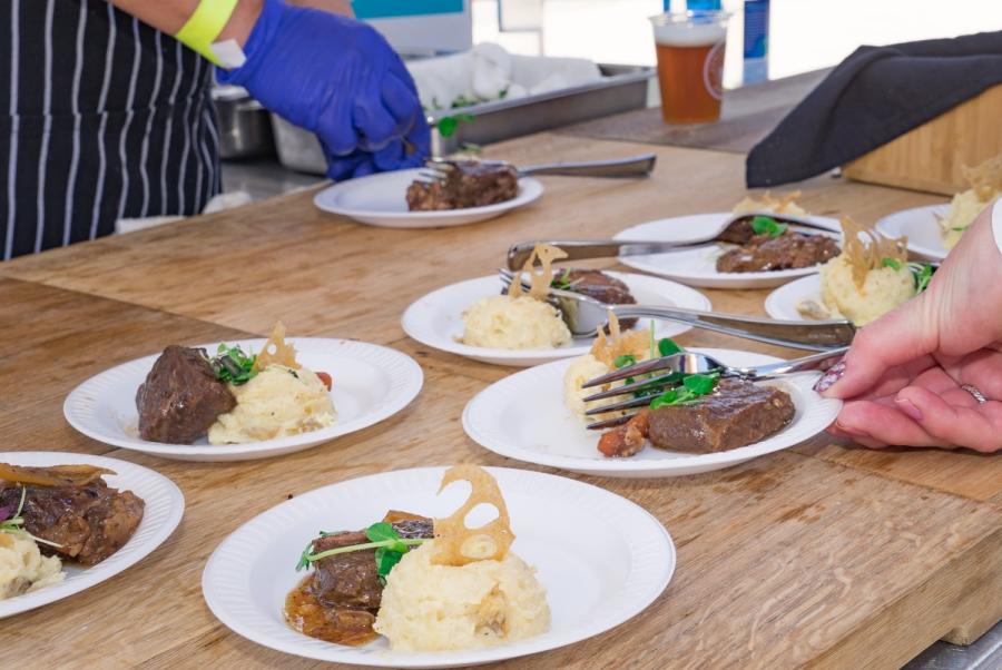 Tasting plate of beef and mashed potatoes lined up on a table