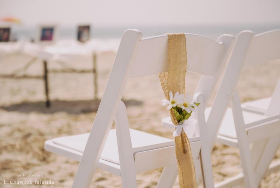 white chairs set up on a beach for a wedding
