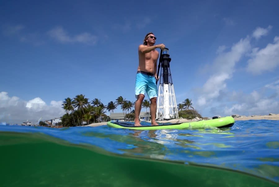 A man on his stand-up paddleboard in the Hillsboro Inlet in Pompano Beach