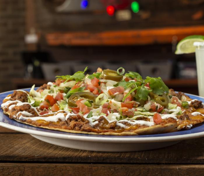 A plate of taco salad on a plate from Rusty Bucket