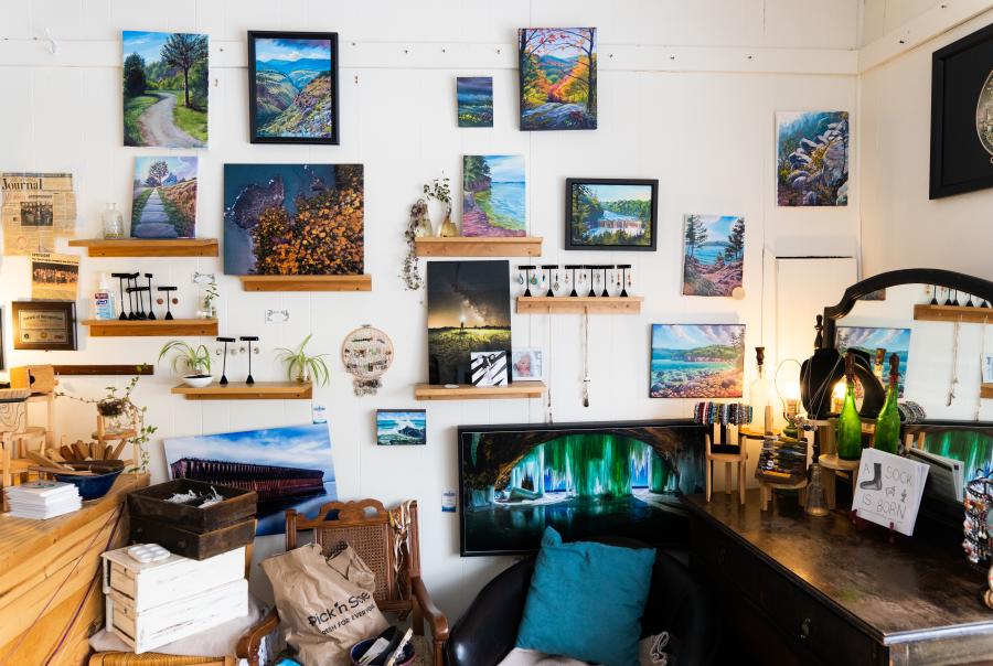 A look inside Madeline Goodman's art studio featuring a wall of local paintings, photographs and handmade jewelery