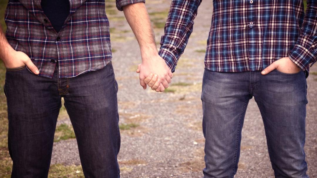 Guys holding hands 