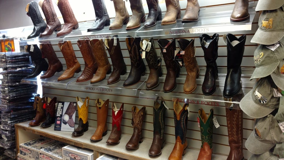 Wall with a variety of cowboy boots displayed in rows