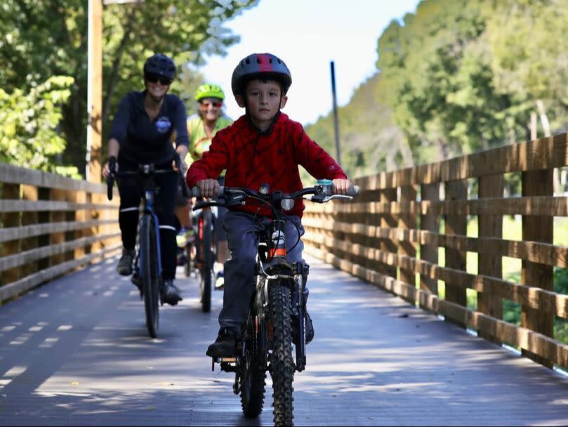 Family bicycling on a bridge in Wabashiki Wetlands, Terre Haute, Indiana
