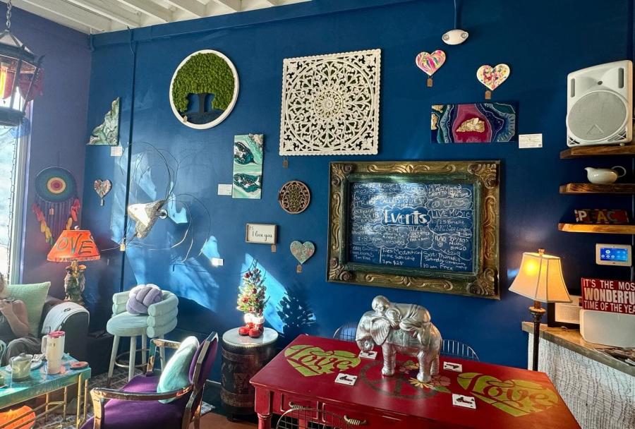 A blue wall filled with heart-art. Little price tags hang from each piece of art